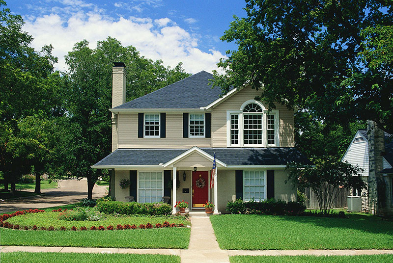 A house with green grass and blue skies